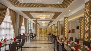 A spacious dining area with long tables, chairs, and a patterned ceiling. - Hotel Mya Yar Pin (Kalaw)