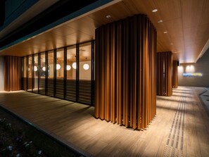 A modern hotel entrance with a wooden facade, glass doors, and a sign reading "Super Hotel". - Super Hotel Yamagata Sakuranbo Higashine Ekimae (Higashine)