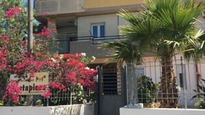 A two-story building with a balcony, a staircase leading to the entrance, and a sign for a breakfast restaurant. - Costapicca B&B (Alcamo)