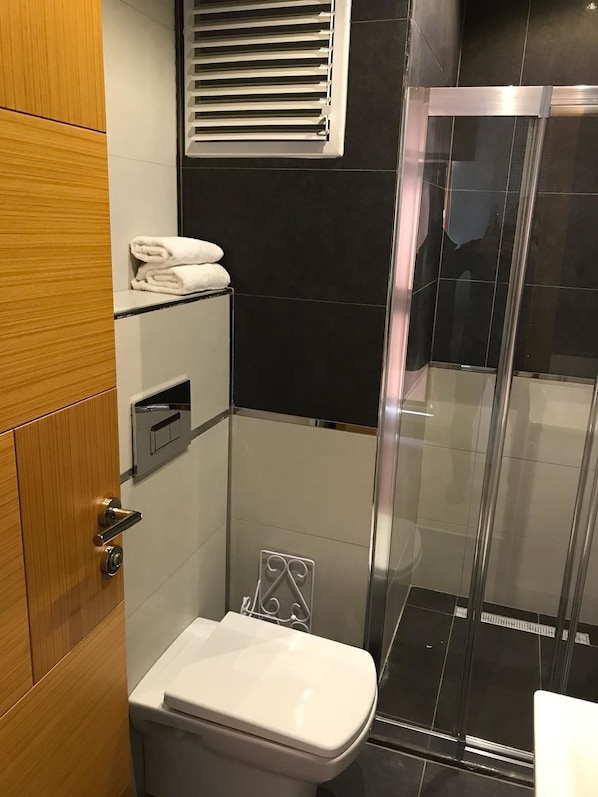 Shower, hair dryer, slippers, towels