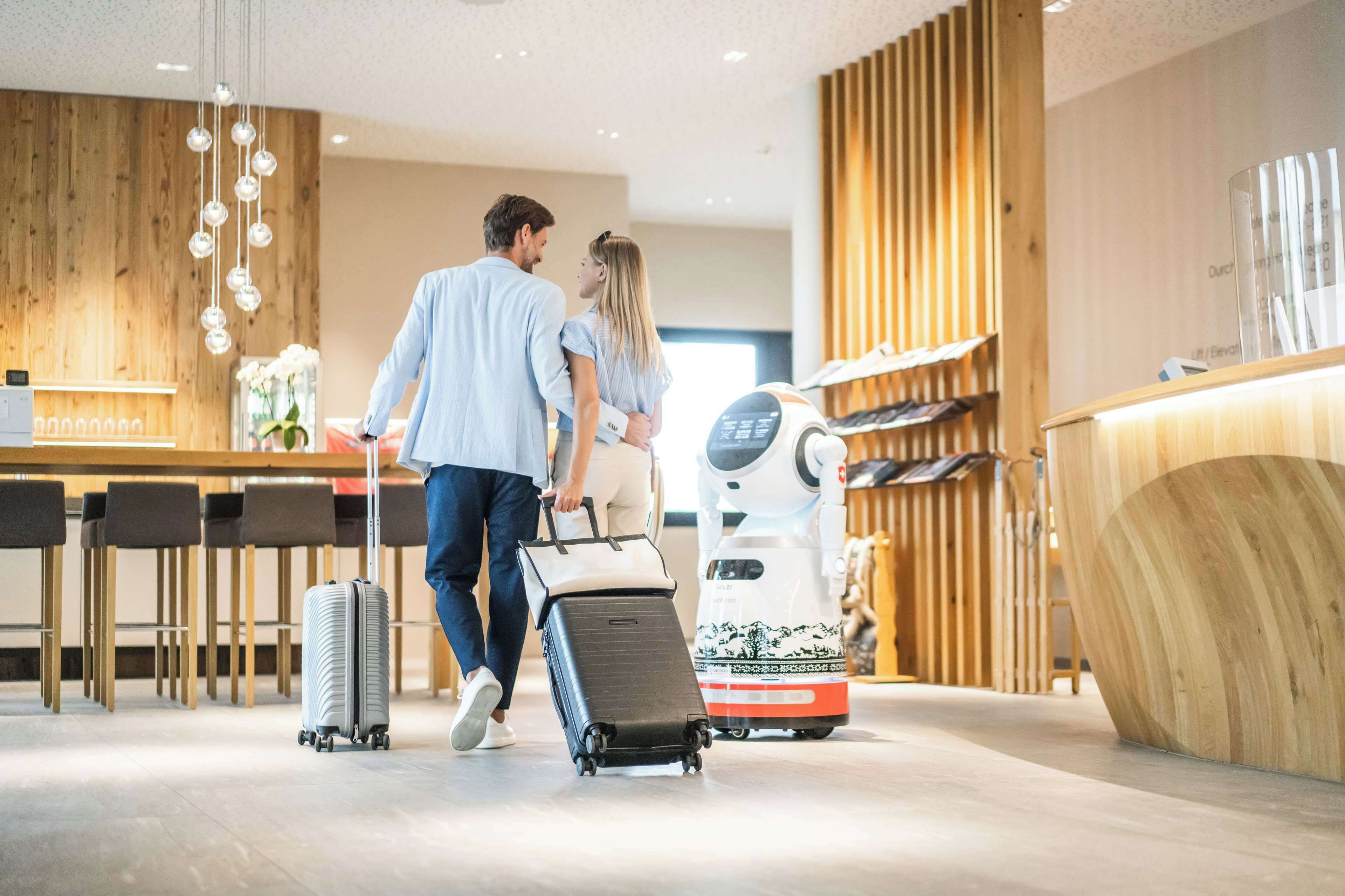 A modern hotel lobby with wooden accents, a reception desk, and a robot for guest assistance.