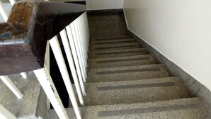 A staircase with concrete steps and white railings. - Metric Annex Hotel (Mombasa)