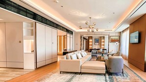 A modern living room with a sofa set, a coffee table, and a TV mounted on the wall. - Ethiopian Skylight Hotel (Addis Ababa)