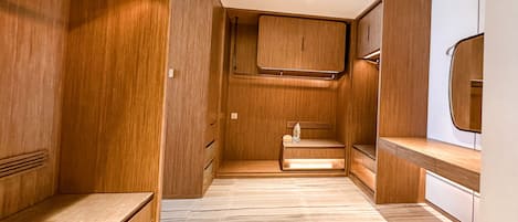 A modern bathroom with wooden cabinetry, a vanity, and a mirror.