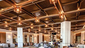 A modern hotel lobby with a high ceiling, exposed ductwork, and contemporary lighting fixtures. - Ethiopian Skylight Hotel (Addis Ababa)