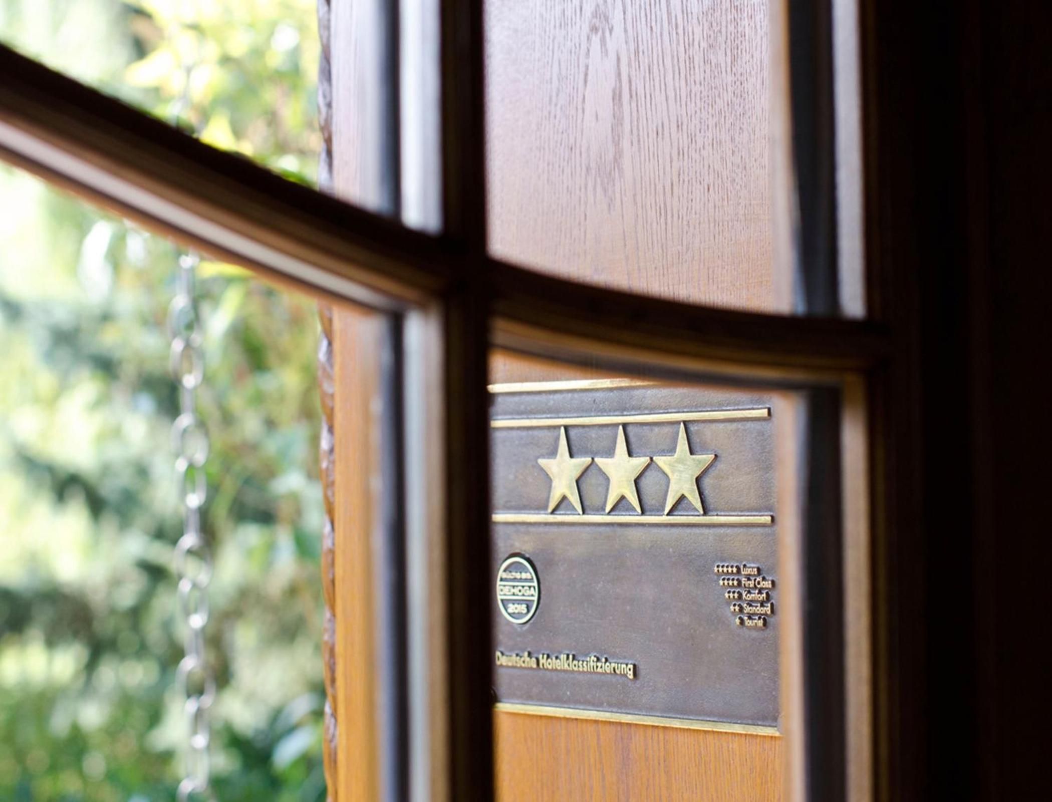 A hotel award plaque with three stars, indicating a high rating.