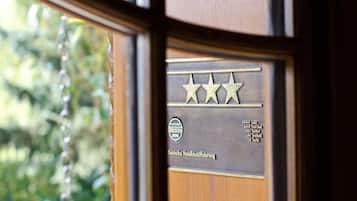 A hotel award plaque with three stars, indicating a high rating.