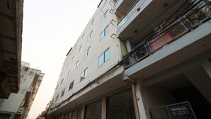 A multi-story building with balconies and a sign indicating a rented office space. - OYO 24248 Hotel Salt (New Delhi)