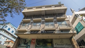 A multi-story building with balconies, a restaurant named "Terrace," and a sign for "Oriental Suites."