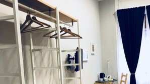 A compact room with a bunk bed, a small desk, a chair, and a sofa. - Palazzo Ferrara (Naples)