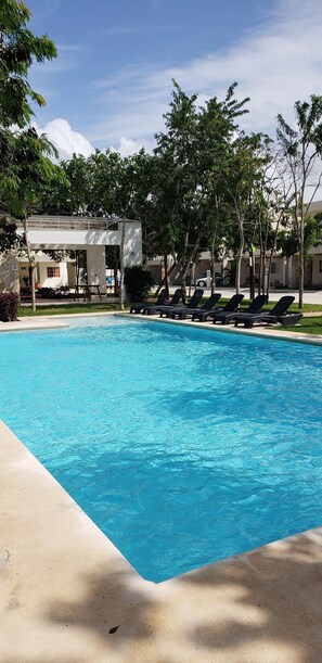 Outdoor pool, open 8:00 AM to midnight, pool umbrellas