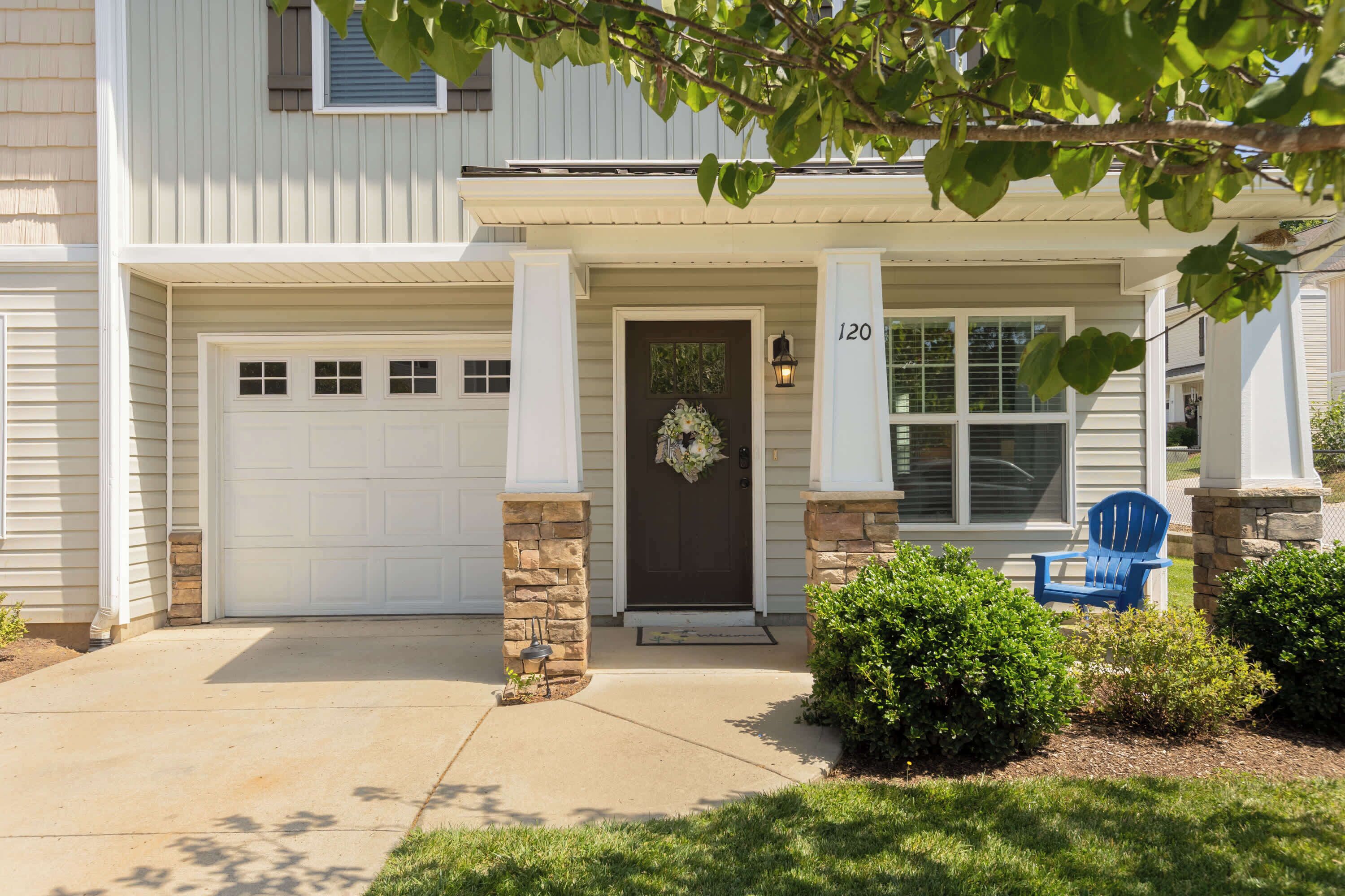 A two-story house with a front garage, a dark front door, and a mailbox.