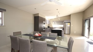 Enjoy meals in this stylish dining area with a glass-top table and comfortable seating.