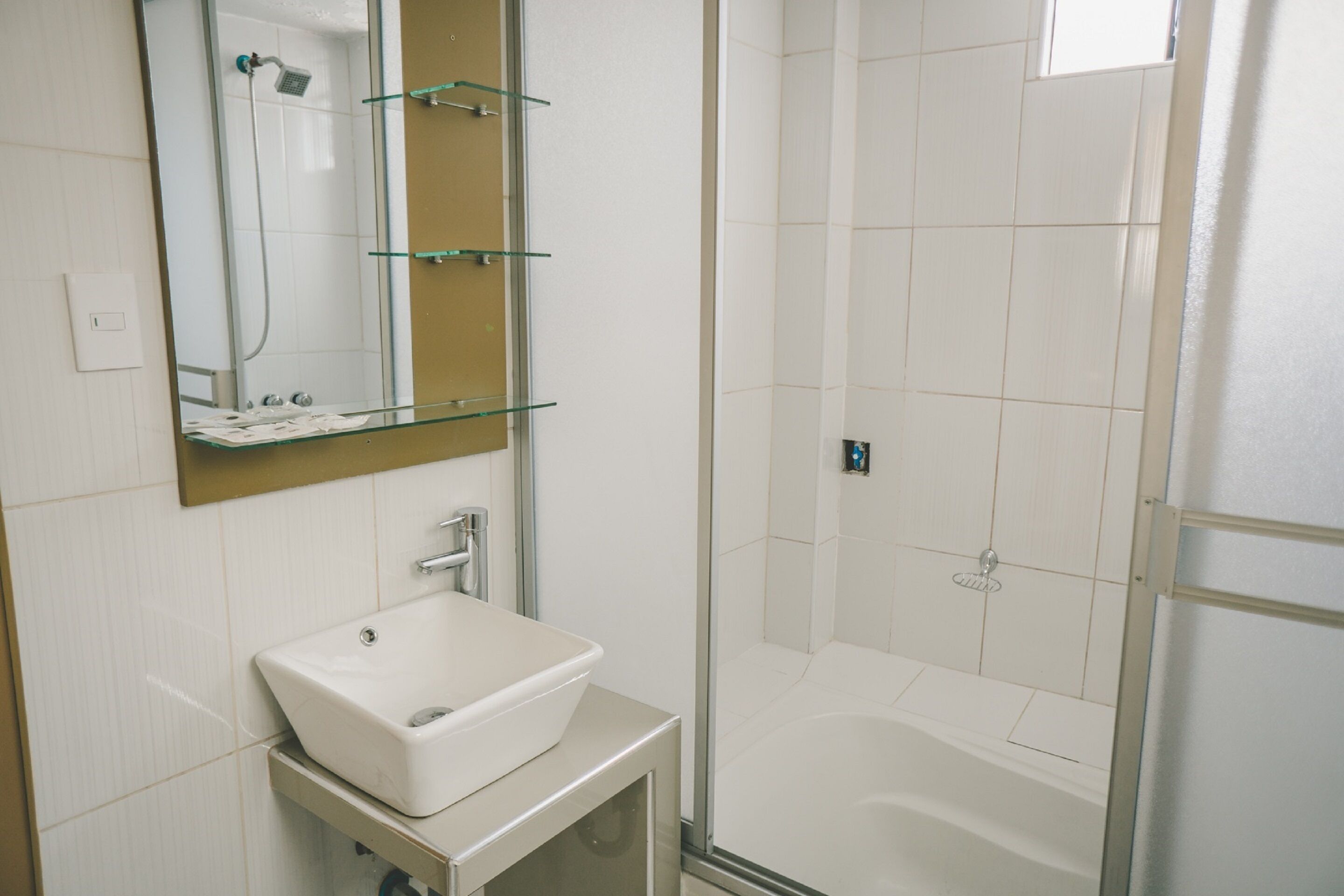 deep-soaking bathtub, rainfall showerhead, free toiletries, towels