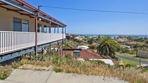 A coastal building with a balcony, a view of the sea, and surrounding houses. - Serindipity - 180 Degrees ocean view (Yanchep)