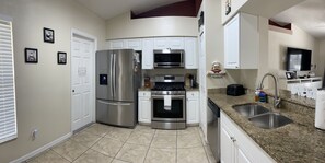 Fridge, microwave, oven, stovetop - Cozy 4 bedroom 2 bathroom Pool Home with game room Close to all the parks. (Clermont)