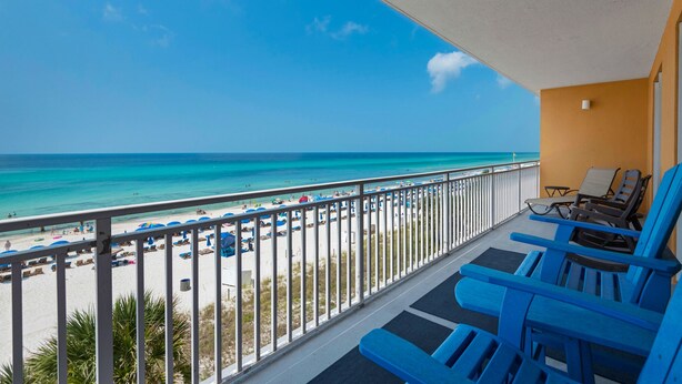 A balcony with blue chairs and a view of the beach and ocean. - Corner 1st Floor, largest two bdrm with Bunk Room and Huge balcony, New Furn. (Panama City Beach)