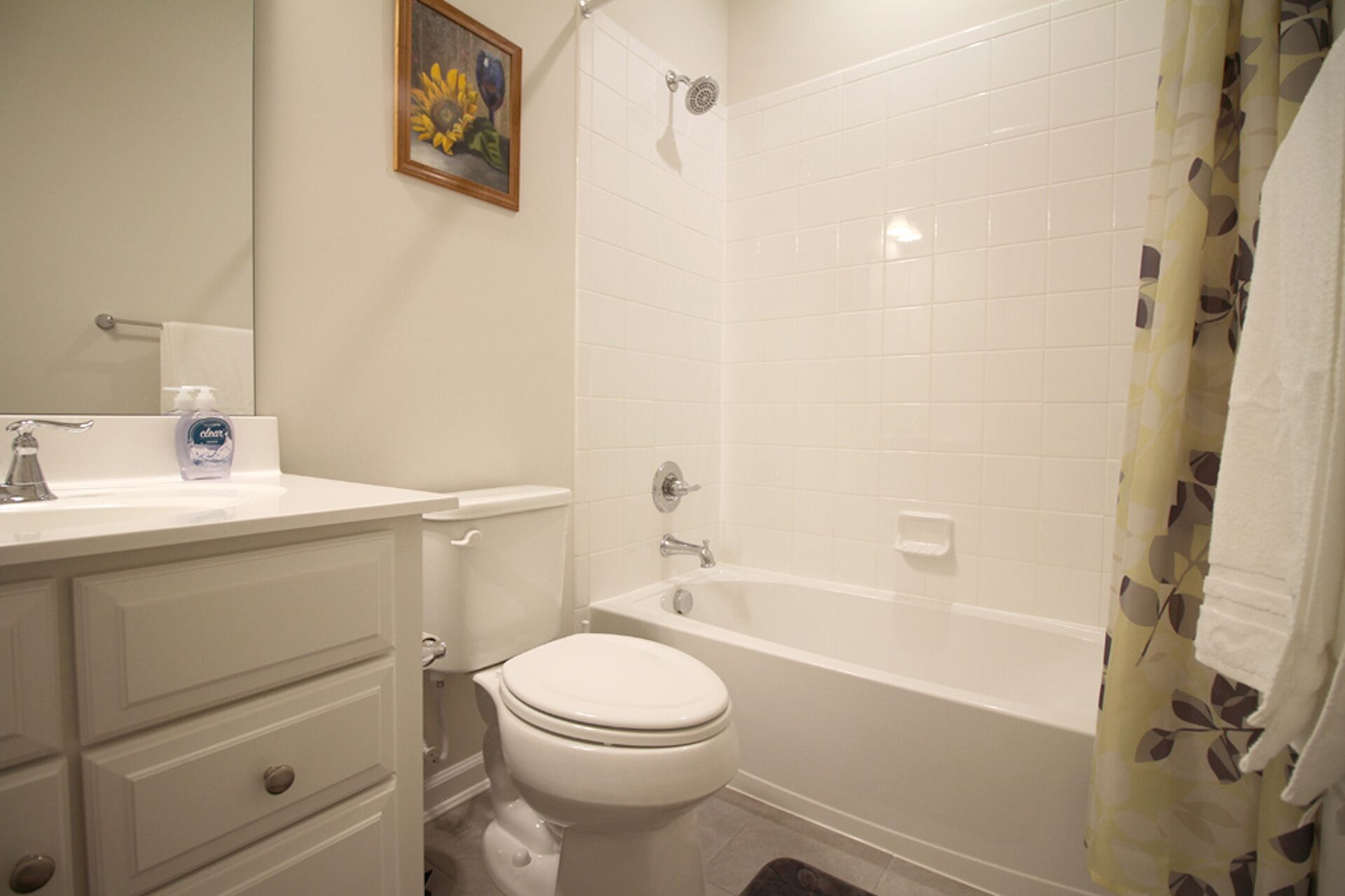 A bathroom with a toilet, sink, and bathtub.