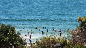 A beach with people swimming and surfing. - Pacific Towers Unit 4, 19 Ormonde Tce Kings Beach (KINGS BEACH)