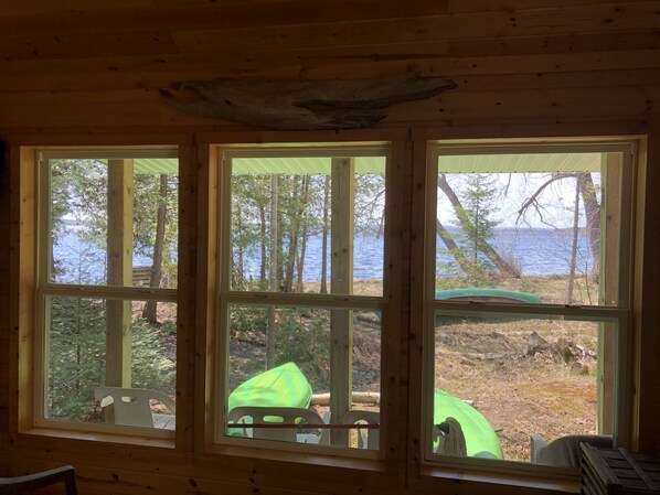 Enjoy breathtaking views of a serene body of water and forest from the comfort of this cozy room.