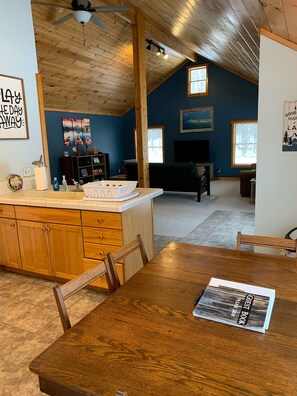 Relax in this inviting space with a dining table, kitchen area, and cozy seating nook.