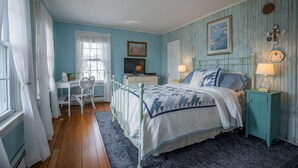 A bedroom with a bed, a desk, and a chair. - Laurel Beach-Milford (Milford)