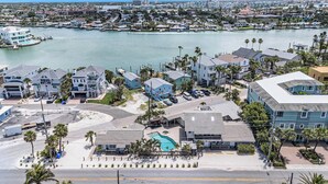 A coastal residential area with houses, a swimming pool, and a marina.