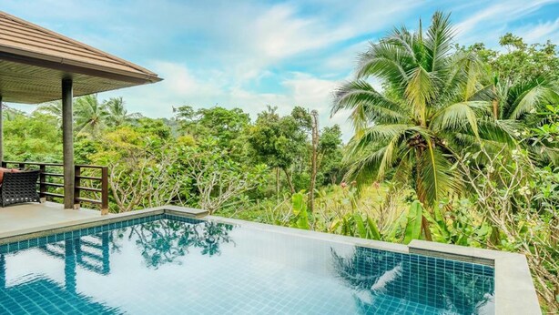 A clear blue pool surrounded by lush greenery and a wooden structure. - 2 Bedroom Pool Villa Nature SDV004 By Samui Dream Villas (Mae Nam)