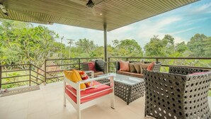 A covered outdoor seating area with wicker furniture, a glass table, and a bed with red bedding. - 2 Bedroom Pool Villa Nature SDV004 By Samui Dream Villas (Mae Nam)