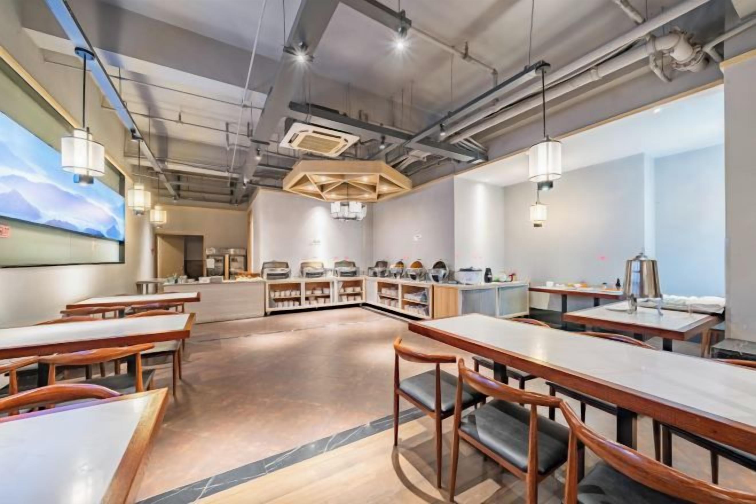 A modern conference room with a long table, chairs, and a projection screen.