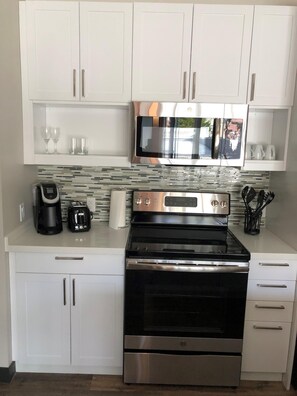 Enjoy cooking in this well-equipped kitchen with a microwave, oven, coffee maker, and toaster.