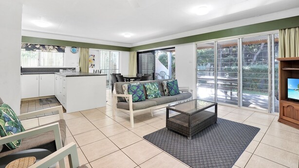 A modern living room with a sofa, coffee table, and TV stand. - Two bedroom unit in central location and only minutes walk to Deadmans... (Point Lookout)