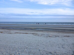 Guests can walk along the sandy shoreline, enjoying the calm sea and scenic views.