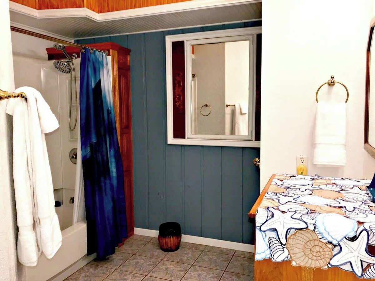 A bathroom with a shower, a bathtub, a toilet, and a sink.