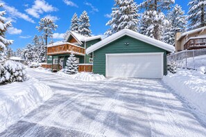 A two-story house with a green garage and a wooden deck. - Buffalo Crossing - Walk to Bear Mtn | Hot Tub + Game Room (Big Bear Lake)