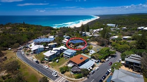 Stunning coastal homes with solar panels and lush surroundings.