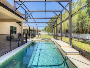 Relax by the pool surrounded by a clean deck and lounge chairs.