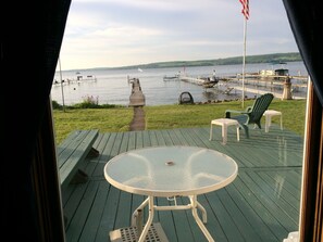 Relax on the deck with a serene lake view, perfect for dining or unwinding.