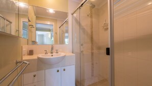 A modern bathroom with a glass shower enclosure, a white sink, and a large mirror. - Watson Street 1, 29, Currimundi (Currimundi)