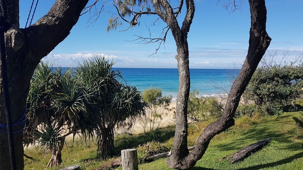 A coastal landscape with a clear view of the ocean, surrounded by trees and vegetation. - Watson Street 1, 29, Currimundi (Currimundi)