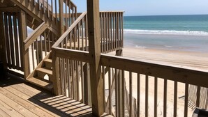 A wooden deck with a staircase leading to a beach view. - Terrapin Station: Oceanfront Home for Vacation Rental, Pet Friendly, Sleeps 10 (Surf City)