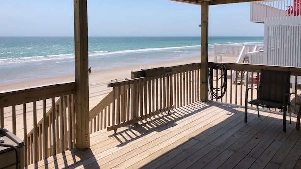 A wooden deck with a view of the beach and ocean. - Terrapin Station: Oceanfront Home for Vacation Rental, Pet Friendly, Sleeps 10 (Surf City)