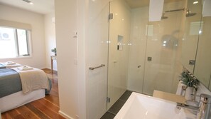 Bathtub, rainfall showerhead, hair dryer, towels