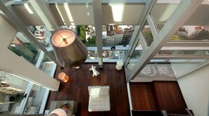 A high-ceilinged room with a large cylindrical lamp, a plush white sofa, and a small table with a vase. - Amazing 2 BR/2.5 BA, 29/30th Floor Penthouse (Buenos Aires)