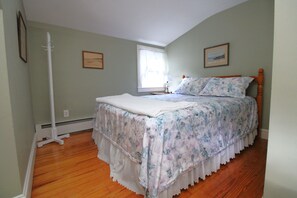 A bedroom with a bed, a window, and two framed pictures on the wall. - 4BR Cape Style Near Saints Landing and Paines Creek (2086) (Brewster)