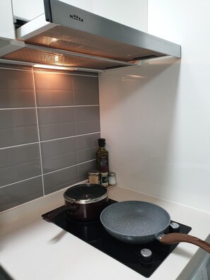 Fridge, microwave, coffee/tea maker, cookware/dishes/utensils