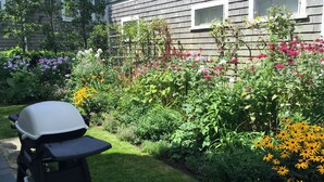 A garden with a grill and a house in the background. - The Folger House on historic Academy Hill, Nantucket (Nantucket)