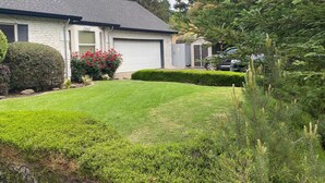 A residential house with a well-maintained lawn, a garage, and a driveway. - Private Spacious Unit. King bed/2 twin xl beds (Citrus Heights)