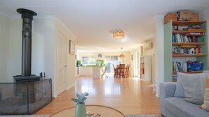 A spacious living room with a fireplace, a dining area, and a kitchen in the background. - BRIGHT GYPSY: Bright (Bright)