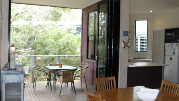 A modern kitchen with a dining area. - Central location - walking distance to beaches, shops and hotel. (Point Lookout)